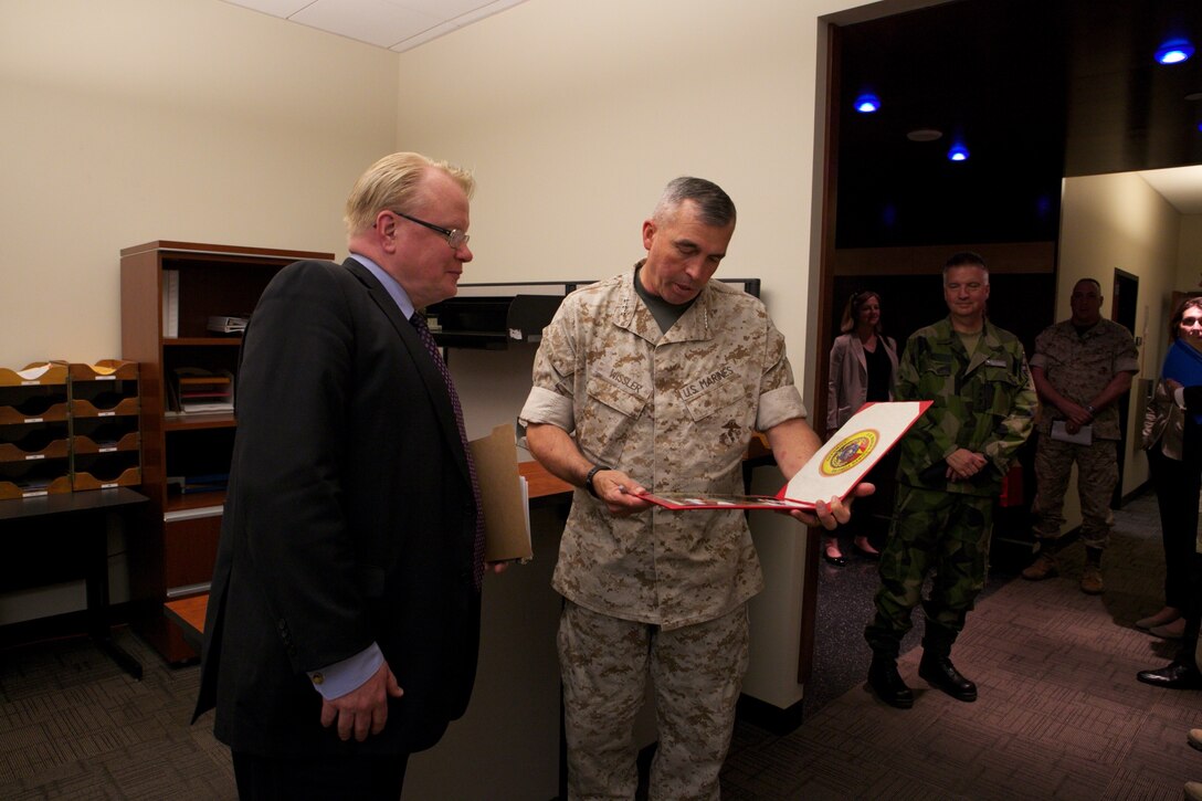 U.S. Marine Forces Command Commanding General Lt. Gen. John E. Wissler presents a photo to Sweden's Minister of Defense Peter Hultqvist during his visit to MARFORCOM in Norfolk, Virginia, June 6. (Official U.S. Marine Corps Photo by Cpl. Calvin Shamoon/ Released)