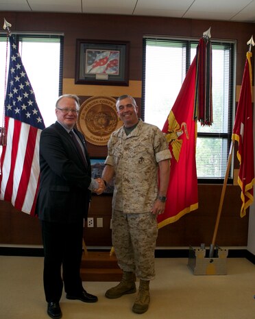 Peter Hultqvist, Sweden's Minister of Defense (left), is greeted by Lt. Gen. John E. Wissler, commanding general of U.S. Marine Forces Command, during his visit to MARFORCOM in Norfolk, Virginia, June 6. (Official U.S. Marine Corps Photo by Cpl. Calvin Shamoon/ Released)