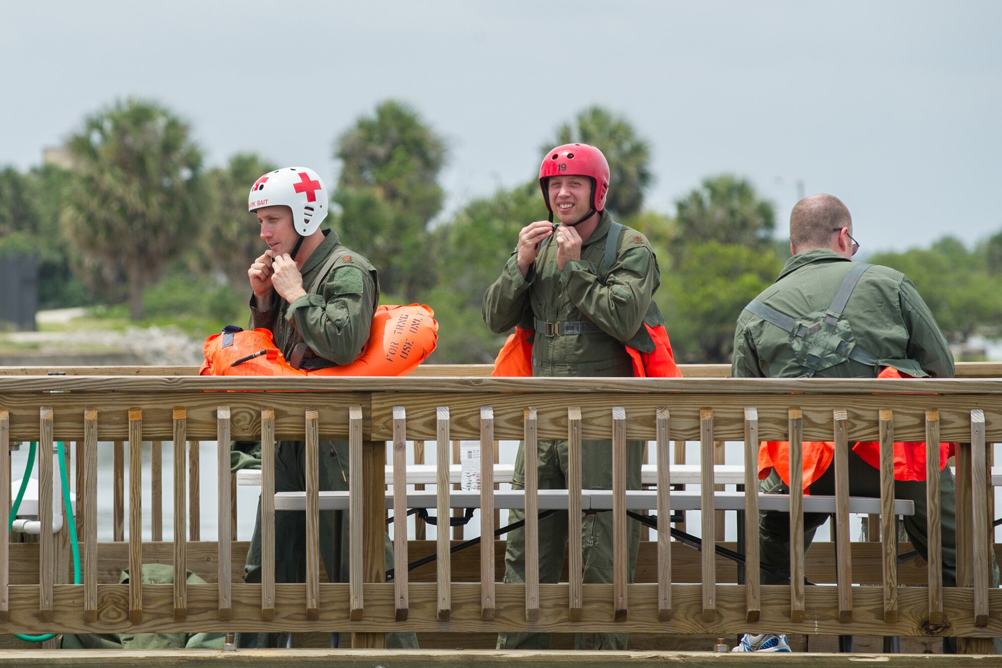 Airmen from the 89th Airlift Squadron and 445th Aeromedical Evacuation Squadron gear up for an aircraft crash scenario. The Airmen deployed rafts on the water, simulating the effect of escaping a plane crash over a body of water. The Airmen learned about water survival skills while waiting to be “rescued.” (U.S. Air Force photos/Benjamin Thacker/Released)