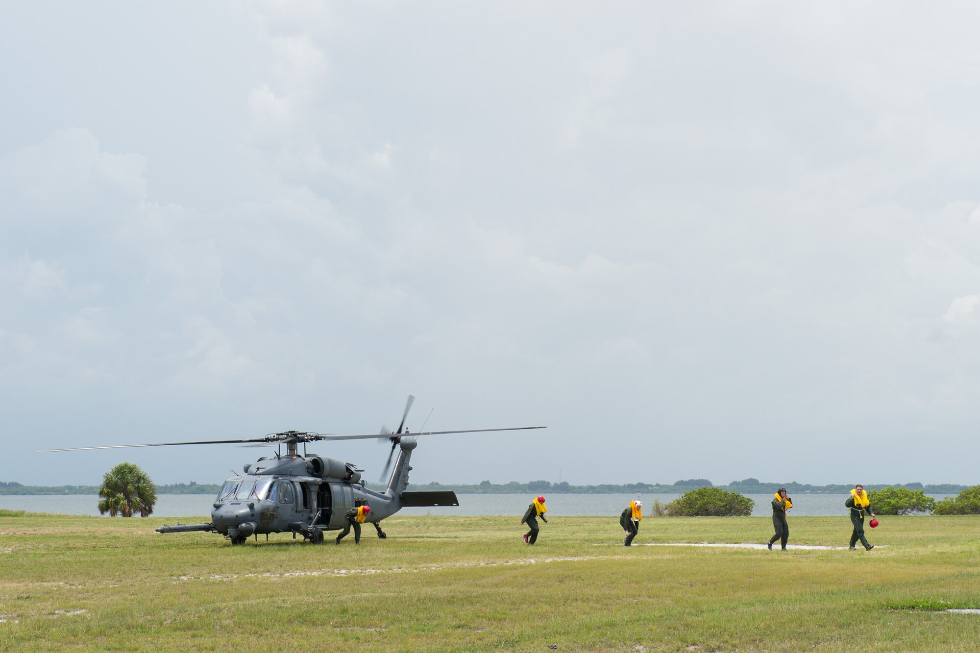 A 301st Rescue Squadron HH-60 Pave Hawk drops off Airmen from the 445th Operations Group after being rescued from the Banana River as part of a water survival training scenario May 17, 2016 at the Marina, Patrick AFB, Fla. Approximately 60 Airmen from the 89th Airlift Squadron, 445th Aeromedical Evacuation Squadron and 445th Operational Support Squadron (OSS provided the training) descended upon Patrick AFB May 17-19 for their annual water and combat survival training. (U.S. Air Force photos/Benjamin Thacker/Released)