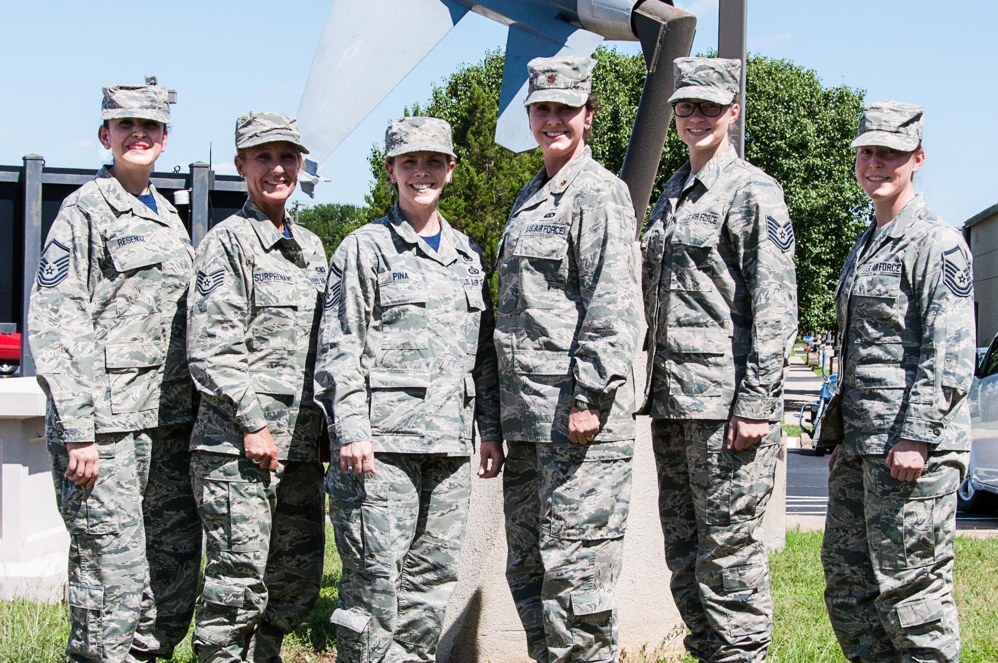 Senior Master Sgt. Lisa Pina (third from left), 301st Force Support Squadron force development superintendent, poses with members from the squadron and her flight, here June 5. Pina, along with her flight, play a vital role in developing and empowering Airmen in the 301st Fighter Wing by helping them connect to resources for degrees, like the Community College of the Air Force (CCAF), along with professional military education, such as on-the-job training or Airman Leadership School. (U.S. Air Force photo by Master Sgt. Joshua Woods)