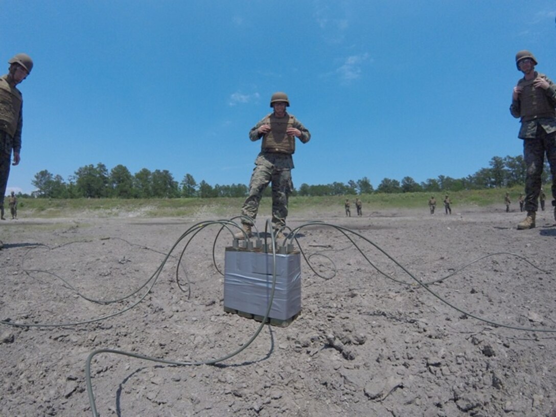 On May 26, 2016 Marines attached to Combat Engineer Officer course 5-16 (CEO 5-16) emplace six one-pound sticks of TNT as part of training with military demolitions. Combat Engineer Officer students emplace and detonate various types of military demolitions; TNT is one of the most common explosives used in the Marine Corps. From left to right: First Lieutenant Jonathan Lanning Keller, Second Lieutenant Thomas Cofer, and Second Lieutenant Nicholas Downey.  
