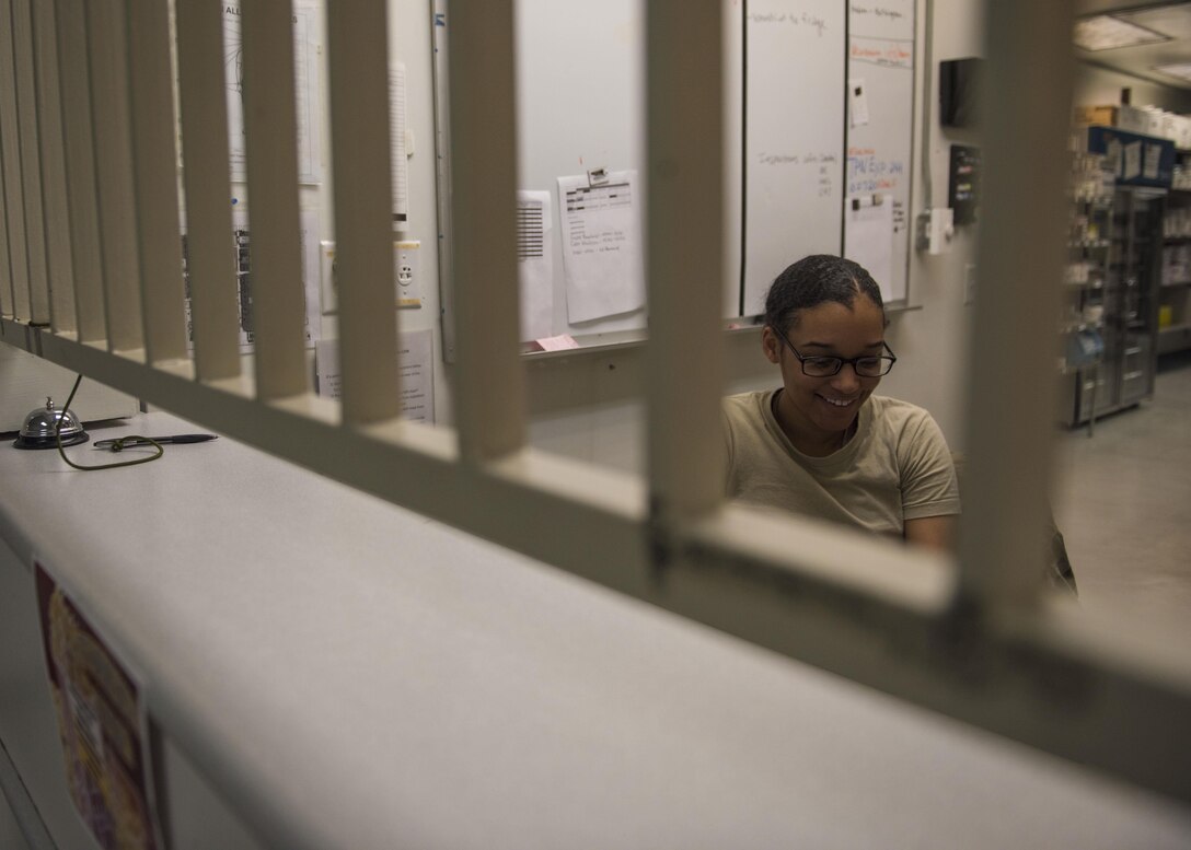Senior Airman Latoya Kirven, 455th Expeditionary Medical Group pharmacy technician, laughs while speaking with another Airman at Bagram Airfield, Afghanistan, June 06, 2016. Airmen of the 455th EMDG pharmacy have made 621 IVs, filled 1,487 prescriptions, and compounded 9,119 doses for patients within the last month. (U.S. Air Force photo by Senior Airman Justyn M. Freeman)