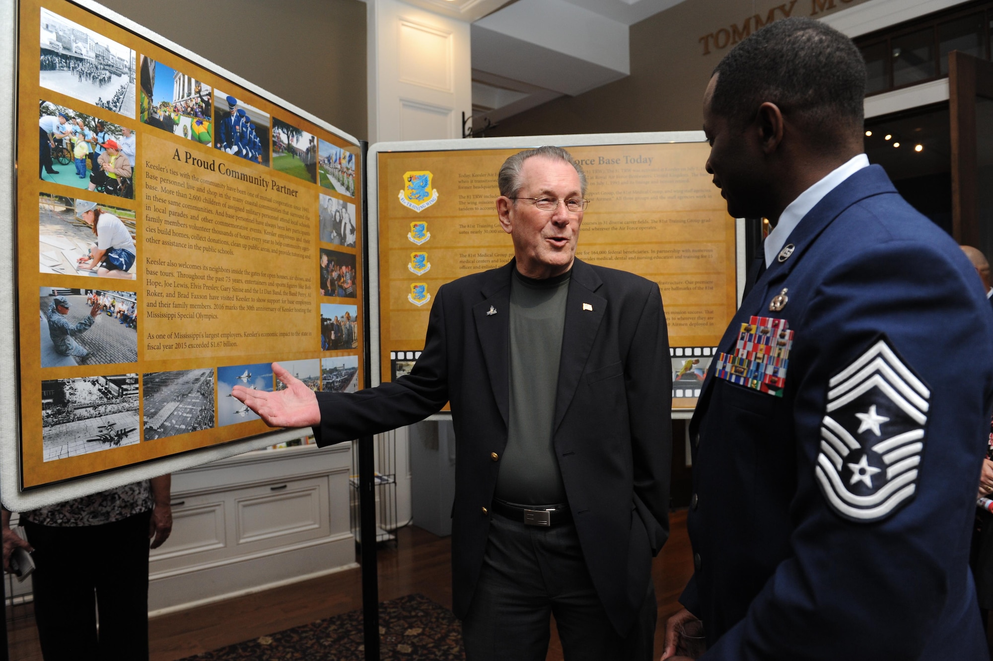 Retired Chief Master Sgt. J.J. Vollmuth and Chief Master Sgt. Harry Hutchinson, 81st Training Wing command chief, view the 14 panel historical display during Keesler’s 75th Anniversary Historical Display Unveiling at the Biloxi Visitors Center June 3, 2016, Biloxi, Miss. The newest 75th anniversary logo was also unveiled and Biloxi Mayor Andrew ‘FoFo’ Gilich read the “Biloxi/Keesler Partnership Day” proclamation. (U.S. Air Force photo by Kemberly Groue)