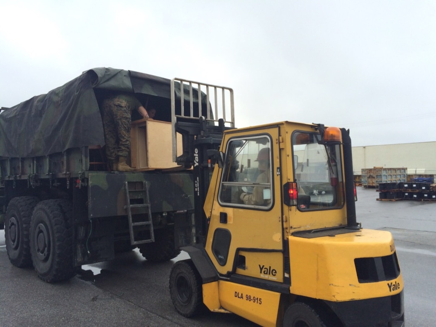 A truckload of couches, chairs, tables and wardrobes from the DLA Disposition Services site at Okinawa, Japan, is readied for shipment to a live fire training area for use by III Marine Expeditionary Force’s Expeditionary Operations Training Group in a live fire training area.