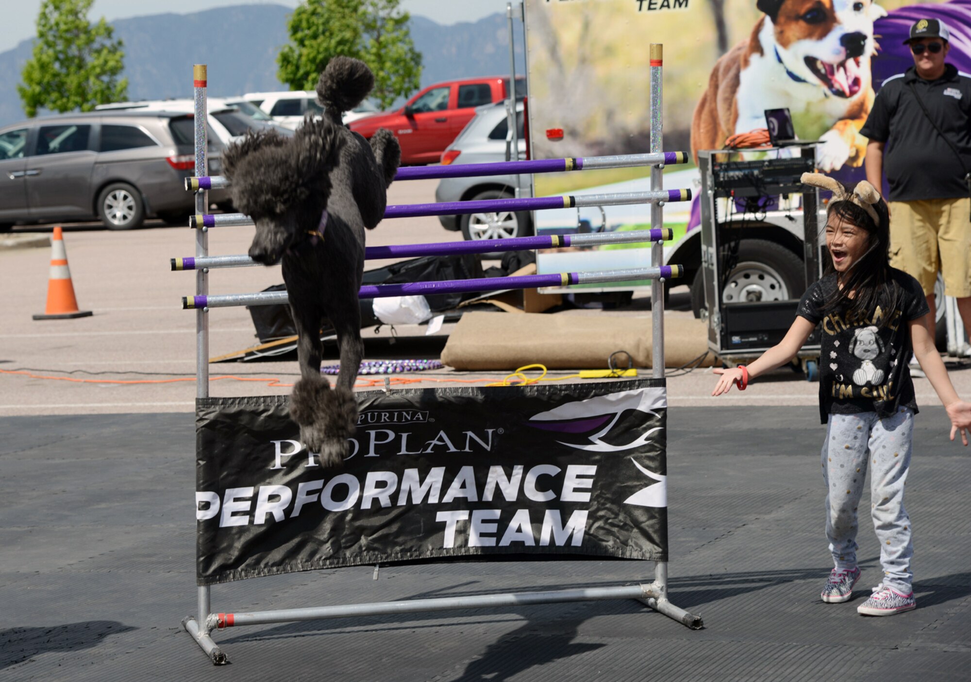 PETERSON AIR FORCE BASE, Colo. – A student from the Peterson Child Development Center assists the Purina Pro Plan Performance Team during a show at the Peterson Exchange June 3, 2016. The show was attended by several children from the CDC. (U.S. Air Force photo by Master Sgt. Jared Marquis)