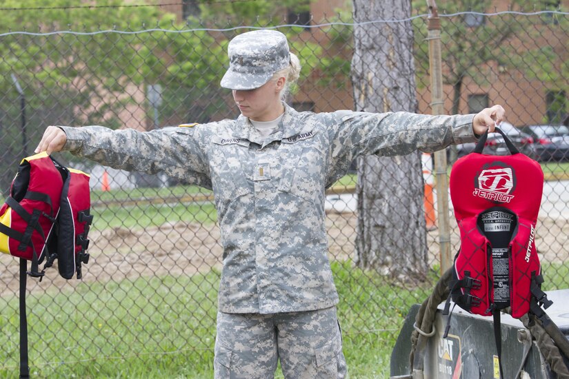 Second Lt. Kaili Owens (left), a U.S. Army Reserve Soldier assigned to the 200th Military Police Command, provides instructions on how to properly wear a life vest during a water and boat safety class as part of the unit's annual safety stand-down training June 4 at Fort Meade, Md. (U.S. Army photo by Sgt. Ida Irby) 