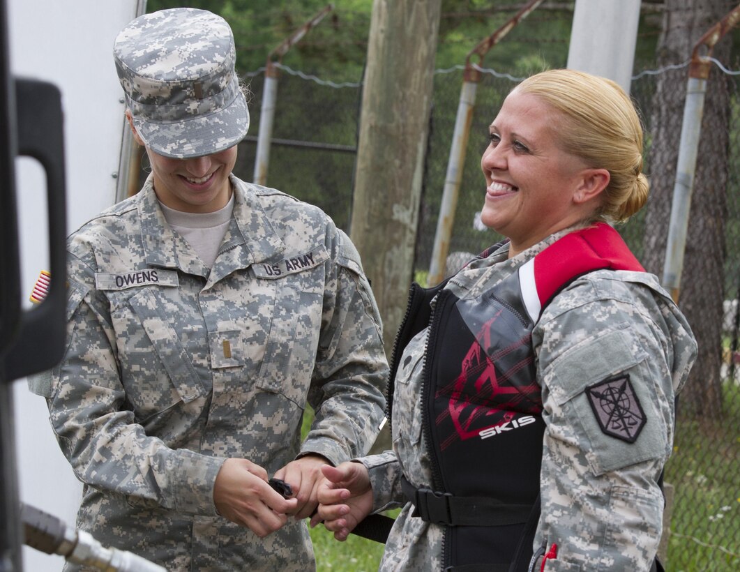 Second Lt. Kaili Owens (left), a U.S. Army Reserve Soldier assigned to the 200th Military Police Command, demonstrates how to properly wear a life vest with Spc. Amanda Knaus, a supply sergeant, while conducting a water and boat safety class during the unit's annual safety stand-down training June 4 at Fort Meade, Md. (U.S. Army photo by Sgt. Ida Irby) 