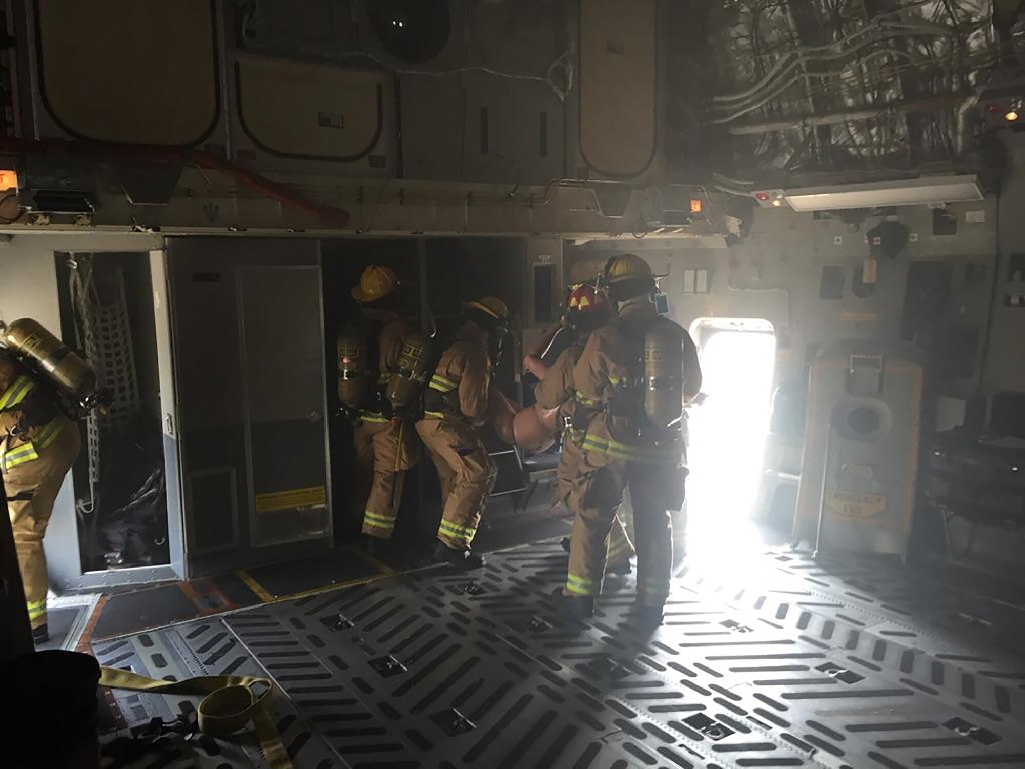 Firefighters remove a “patient” from a smoke-filled 445th Airlift Wing C-17 Globemaster III during a training exercise at Toledo Airport Express, Toledo Ohio. Approximately 300 participants representing 37 organizations from 13 states participated in the exercise. (U.S. Air Force photo/Senior Master Sgt. Craig Essert)