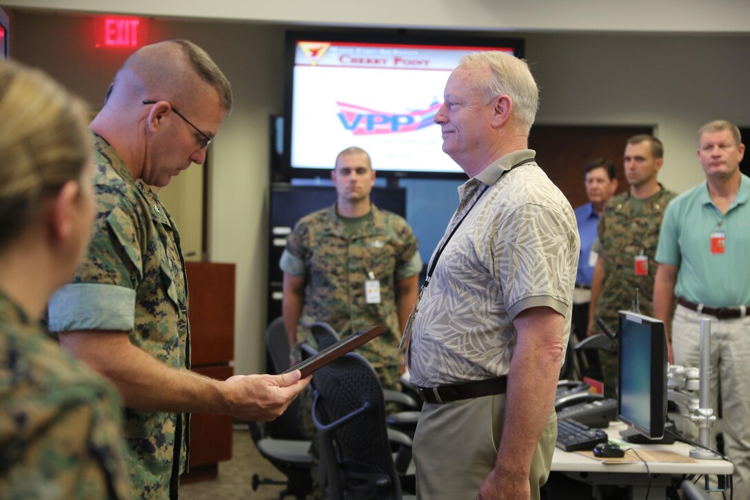 Marine Corps Community Services representatives receive an award during a Voluntary Protection Program Gold status achievement ceremony at Marine Corps Air Station Cherry Point, N.C., May 27, 2016. Six departments were among the first to achieve Gold status within MCAS Cherry Point VPP. Gold status is achieved when all safety protocols implemented by the VPP are completed and maintained. Some of those requirements involve monthly supervisor inspections, achieving 90-percent medical surveillance or higher, completing VPP passports and completing Occupational Safety and Health Administration training. The MCCS was recognized for accumulating 1 million mishap-free work hours. (U.S. Marine Corps photo by Cpl. N.W. Huertas/ Released)