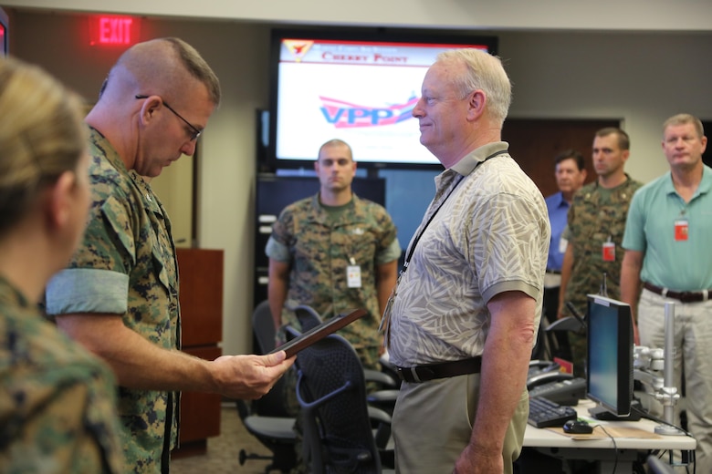 Marine Corps Community Services representatives receive an award during a Voluntary Protection Program Gold status achievement ceremony at Marine Corps Air Station Cherry Point, N.C., May 27, 2016. Six departments were among the first to achieve Gold status within MCAS Cherry Point VPP. Gold status is achieved when all safety protocols implemented by the VPP are completed and maintained. Some of those requirements involve monthly supervisor inspections, achieving 90-percent medical surveillance or higher, completing VPP passports and completing Occupational Safety and Health Administration training. The MCCS was recognized for accumulating 1 million mishap-free work hours. (U.S. Marine Corps photo by Cpl. N.W. Huertas/ Released)