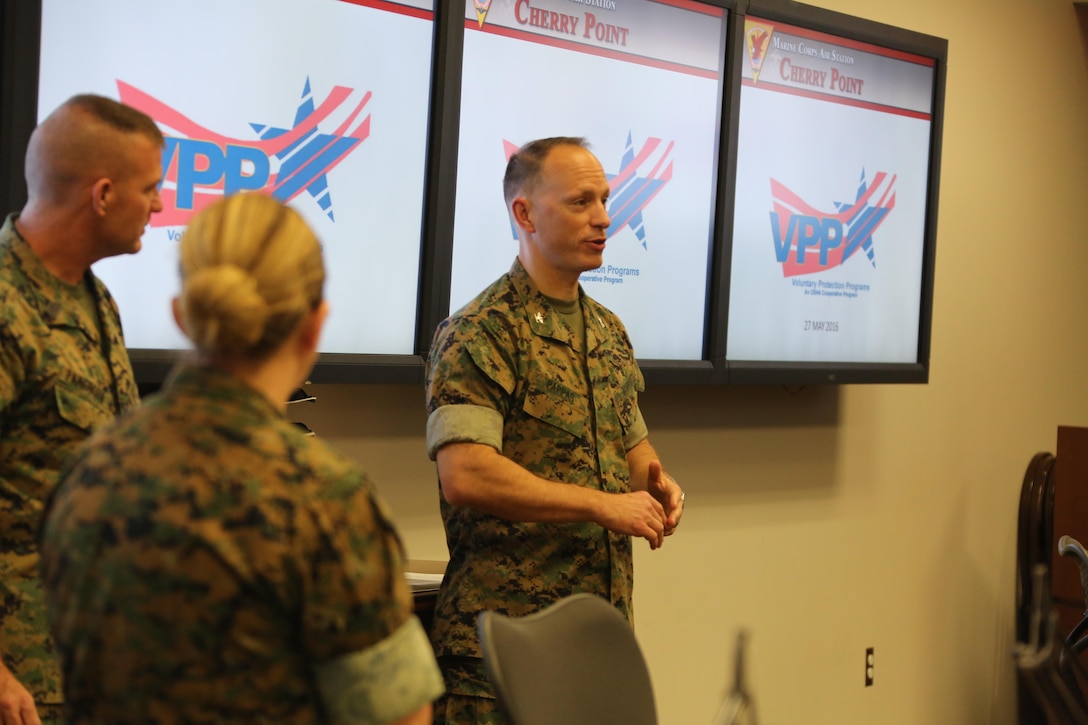 Col. Chris C. Pappas III addresses a crowd during a Voluntary Protection Program Gold status achievement ceremony at Marine Corps Air Station Cherry Point, N.C., May 27, 2016. Six departments were among the first to achieve Gold status within MCAS Cherry Point VPP. Gold status is achieved when all safety protocols implemented by the VPP are completed and maintained. Some of those requirements involve monthly supervisor inspections, achieving 90-percent medical surveillance or higher, completing VPP passports and completing Occupational Safety and Health Administration training. Pappas is the air station commanding officer. (U.S. Marine Corps photo by Cpl. N.W. Huertas/ Released) 