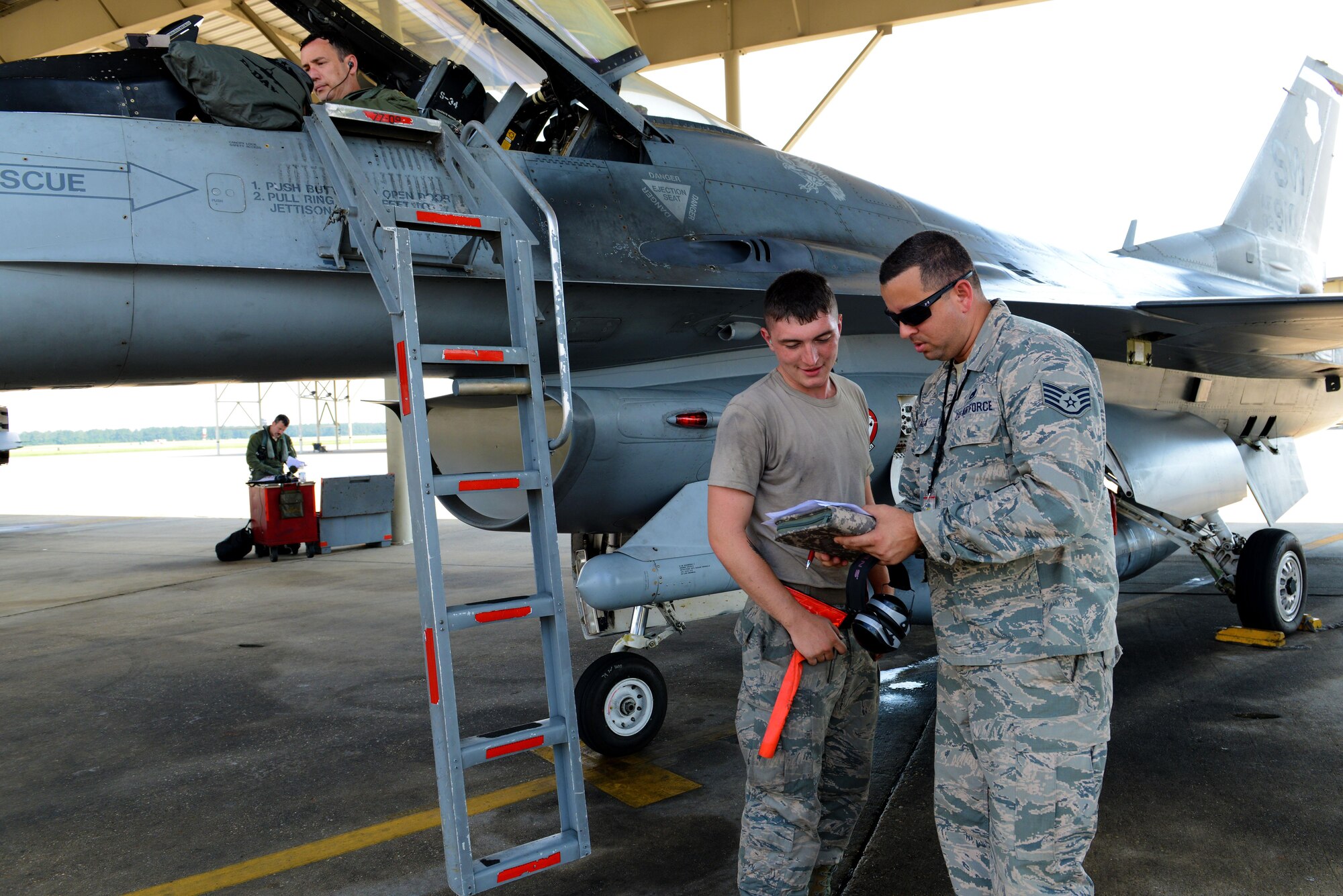 U.S. Air Force Staff Sgt. Edgar Ayala, 20th Maintenance Group quality assurance inspector, speaks with an Airman about an inspection at Shaw Air Force Base, S.C., June 2, 2016. The 20th MXG QA uses the data gathered from inspections to brief supervisors about maintenance trends occurring, which provides an opportunity to take preventative measures to reverse continuing trends. (U.S. Air Force photo by Airman 1st Class Destinee Dougherty)