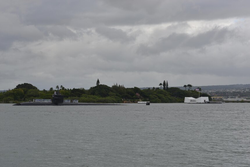 160606-N-LY160-088
PEARL HARBOR (June 6, 2016) Sailors, assigned to the Los Angeles-class fast-attack submarine USS Houston (SSN 713),  render honors to the USS Arizona Memorial as the ship departs Joint Base Pearl Harbor-Hickam for the final time, June 6. Houston is en route to Puget Sound Naval Shipyard in Bremerton, Washington, to commence its inactivation process and decommissioning after 33 years of service. (U.S. Navy photo by Mass Communication Specialist 2nd Class Michael H. Lee/Released)