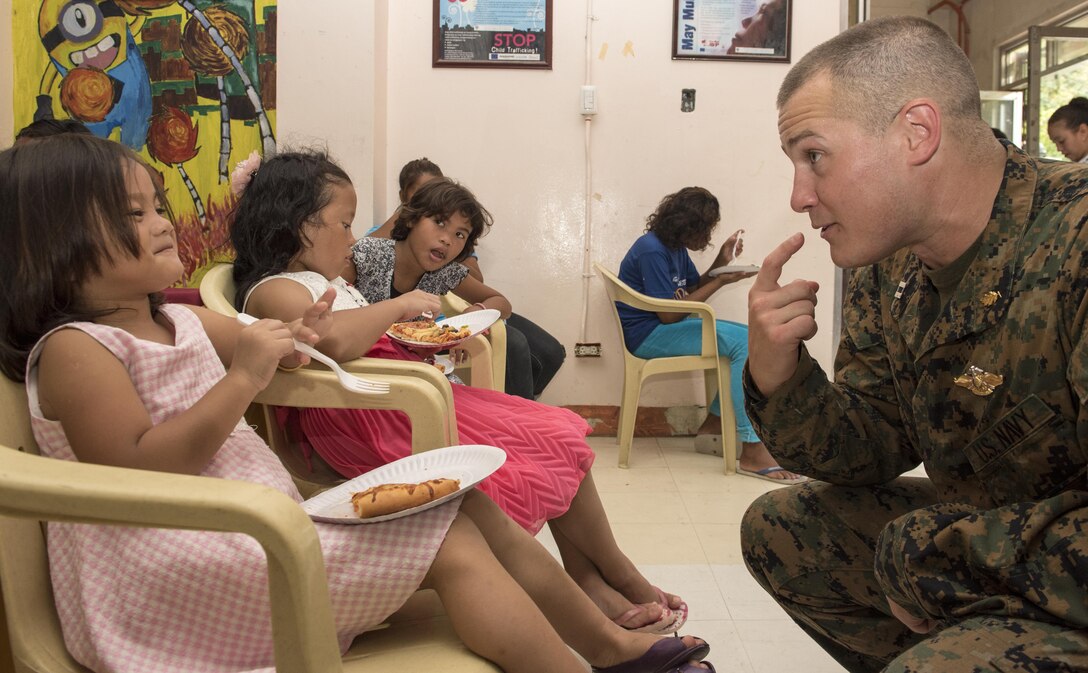 Navy Lt. Derek Chamberlain bonds with a young resident at a social development center in Subic Bay, Philippines, June 6, 2016, during a Project Handclasp outreach program as part of Cooperation Afloat Readiness and Training Philippines 2016. The annual maritime exercises include nine partner nations. Navy photo by Petty Officer 3rd Class Joshua Fulton