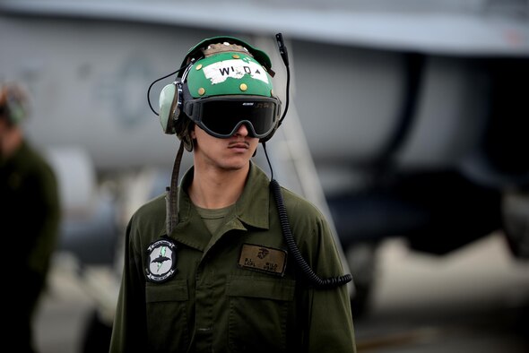 U.S. Marine Corps Lance Cpl. B.L. Wild, an F-18 Hornet power line mechanic assigned to Fixed Marine All-Weather Fighter Attack Squadron 242, Marine Corps Air Station Iwakuni, Japan, awaits the arrival of pilots June 7, 2016, during RED FLAG-Alaska (RF-A) 16-2, at Eielson Air Force Base, Alaska. RF-A provides training for deployed maintenance and support personnel in sustainment of large force deployed operations. (U.S. Air Force photo by Tech. Sgt. Steven R. Doty)