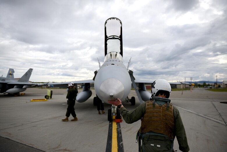 A U.S. Marine Corps F-18 Hornet pilot assigned to the Fixed Marine All-Weather Fighter Attack Squadron 242, Marine Corps Air Station Iwakuni, Japan, conducts a pre-flight inspection June 7, 2016, during RED FLAG-Alaska16-2, at Eielson Air Force Base, Alaska. The F-18 is a twin-engine supersonic, all-weather carrier-capable multirole combat jet, designed as both a fighter and attack aircraft. (U.S. Air Force photo by Tech. Sgt. Steven R. Doty)