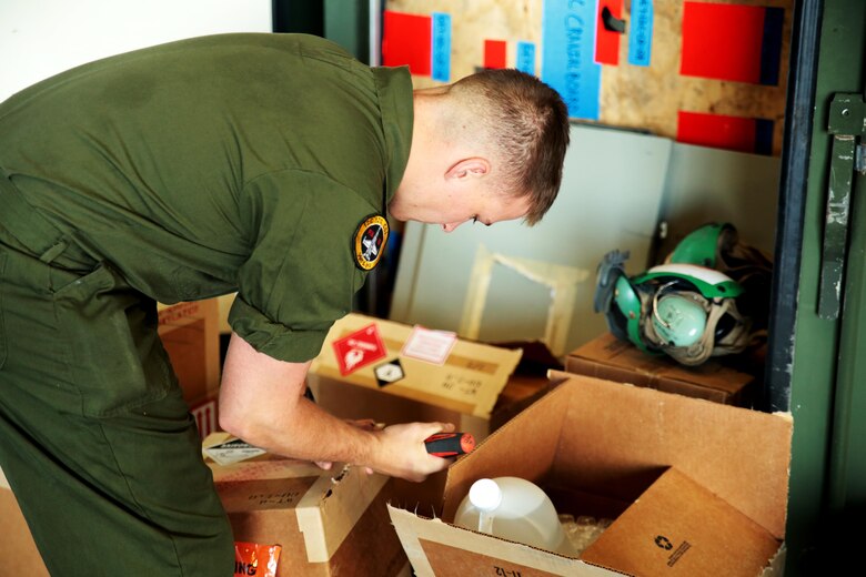 U.S. Marine Corps Cpl. John Kilmartin, an air frame and corrosion control maintainer with Marine Fighter Attack Squadron (VMFA) 314, unpacks paint and anti-corrosion chemicals for use during exercise Red Flag-Alaska 16-2 at Eielson Air Force Base, Alaska, June 4, 2016. Exercise Red Flag-Alaska 16-2 provides VMFA-314 and Marine All-Weather Fighter Attack Squadron (VMFA) 242, based out of Marine Corps Station Iwakuni, Japan, the opportunity to train with joint and international units, increasing their combat skills by participating simulated combat situations in a realistic threat environment. (U.S. Marine photo by Lance Cpl. Donato Maffin/Released)