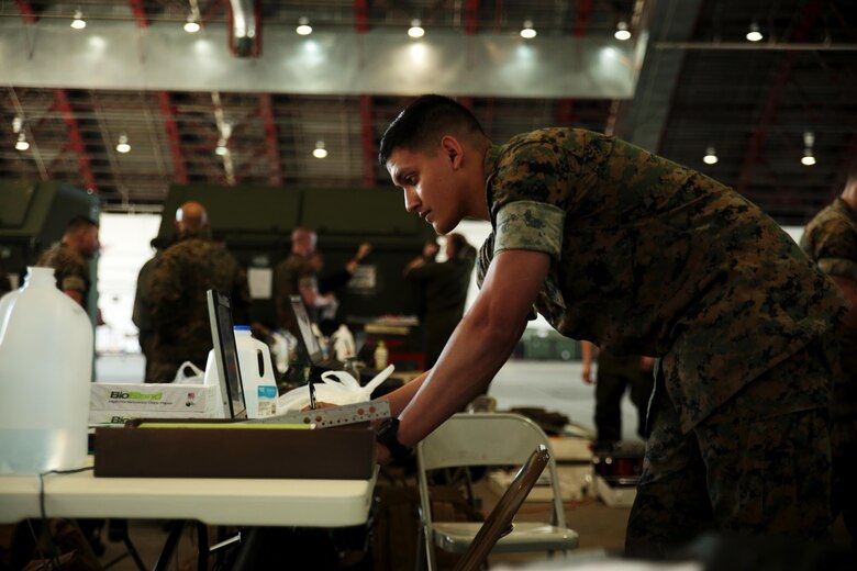 U.S. Marine Corps Cpl. Marco Lopez, an aviation supply specialist with Marine Aviation Logistics Squadron 12, sets up his computer in preparation to support Marine Fighter Attack Squadron (VMFA) 314 and Marine All-Weather Fighter Attack Squadron (VMFA) 242 during exercise Red Flag-Alaska 16-2 at Eielson Air Force Base June 4, 2016. Exercise Red Flag-Alaska 16-2 provides VMFA-314 and Marine All-Weather Fighter Attack Squadron (VMFA) 242, based out of Marine Corps Station Iwakuni, Japan, the opportunity to train with joint and international units, increasing their combat skills by participating simulated combat situations in a realistic threat environment. (U.S. Marine photo by Lance Cpl. Donato Maffin/Released)