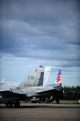 A U.S. Marine Corps F-18 Hornet assigned to Fixed Marine All-Weather Fighter Attack Squadron 242, Marine Corps Air Station Iwakuni, Japan, taxis past a Republic of Singapore Air Force F-16 Fighting Falcon, June 7, 2016, during RED FLAG-Alaska (RF-A) 16-2, at Eielson Air Force Base, Alaska. In addition to enabling joint and international units to work side-by-side, RF-A allows coalition forces to exchange tactics, techniques and procedures while improving interoperability. (U.S. Air Force photo by Tech. Sgt. Steven R. Doty)