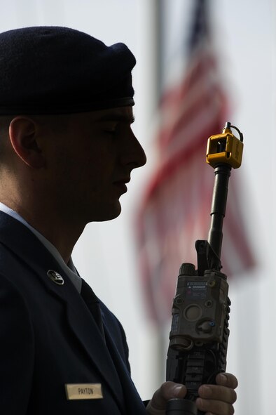 Airman 1st Class Kyle Payton, a 374th Security Forces Squadron patrolman, holds a M4 carbine rifle during a retreat ceremony May 19, 2016 at Yokota Air Base, Japan. The ceremony was held during Police Week, which recognizes the service of law enforcement members and military working dogs who put their lives at risk every day. (U.S. Air Force photo by Yasuo Osakabe/Released)