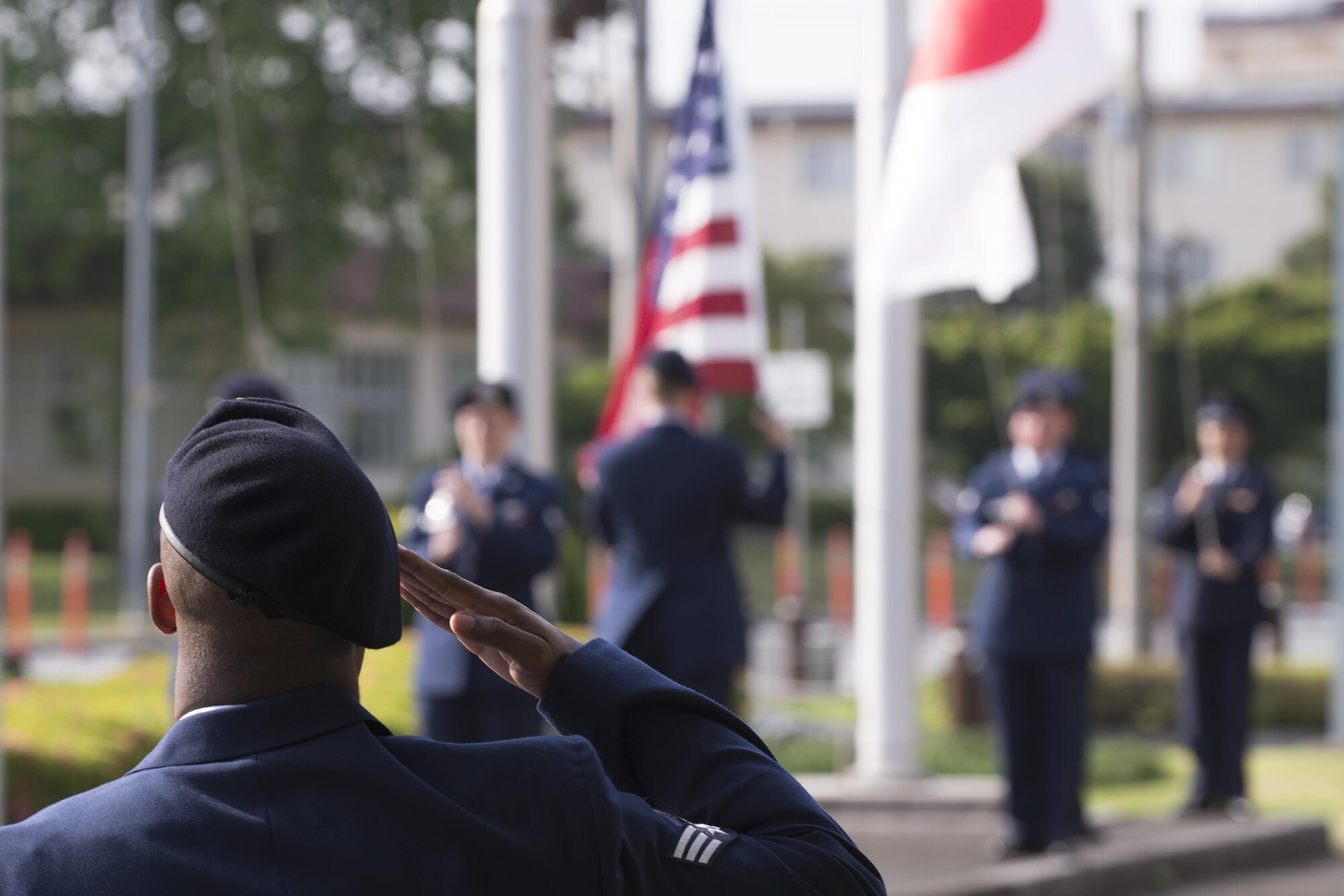 An Airman with the 374th Security Forces Squadron salutes during a retreat ceremony May 19, 2016 at Yokota Air Base, Japan. The security forces-lead ceremony wrapped up the squadron’s National Police Week activities while giving them the opportunity to mourn their fallen Military Working Dog Alan/L220 who recently passed away from cancer. (U.S. Air Force photo by Yasuo Osakabe/Released)