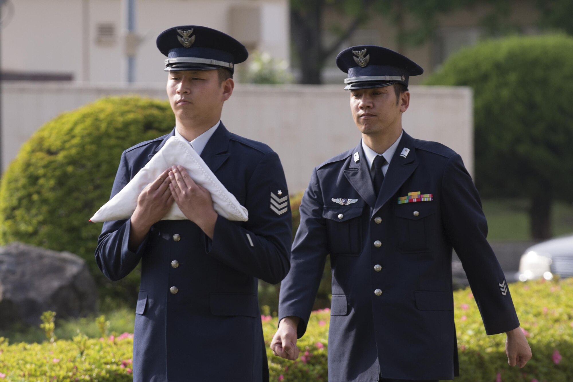 Japan Air Self-Defense Force members from the Operations Support Wing carry the Japanese Flag during a retreat ceremony May 19, 2016 at Yokota Air Base, Japan. JASDF counterparts also participated in the National Police Week events. (U.S. Air Force photo by Yasuo Osakabe/Released) 