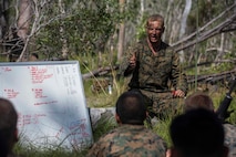 U.S. Marine Corps Capt. Chris Brock, Commanding Officer of Company A, 1st Battalion, 1st Marine Regiment, debriefs the Marines after performing platoon live fire at Shoalwater Bay, Queensland, Australia, May 22, 2016. The platoon-level live fire and maneuver was part of Exercise Southern Jackaroo, a combined training opportunity during Marine Rotational Force – Darwin (MRF-D). MRF-D is a six-month deployment of Marines into Darwin, Australia, where they will conduct exercises and train with the Australian Defence Forces, strengthening the U.S.-Australia alliance.
