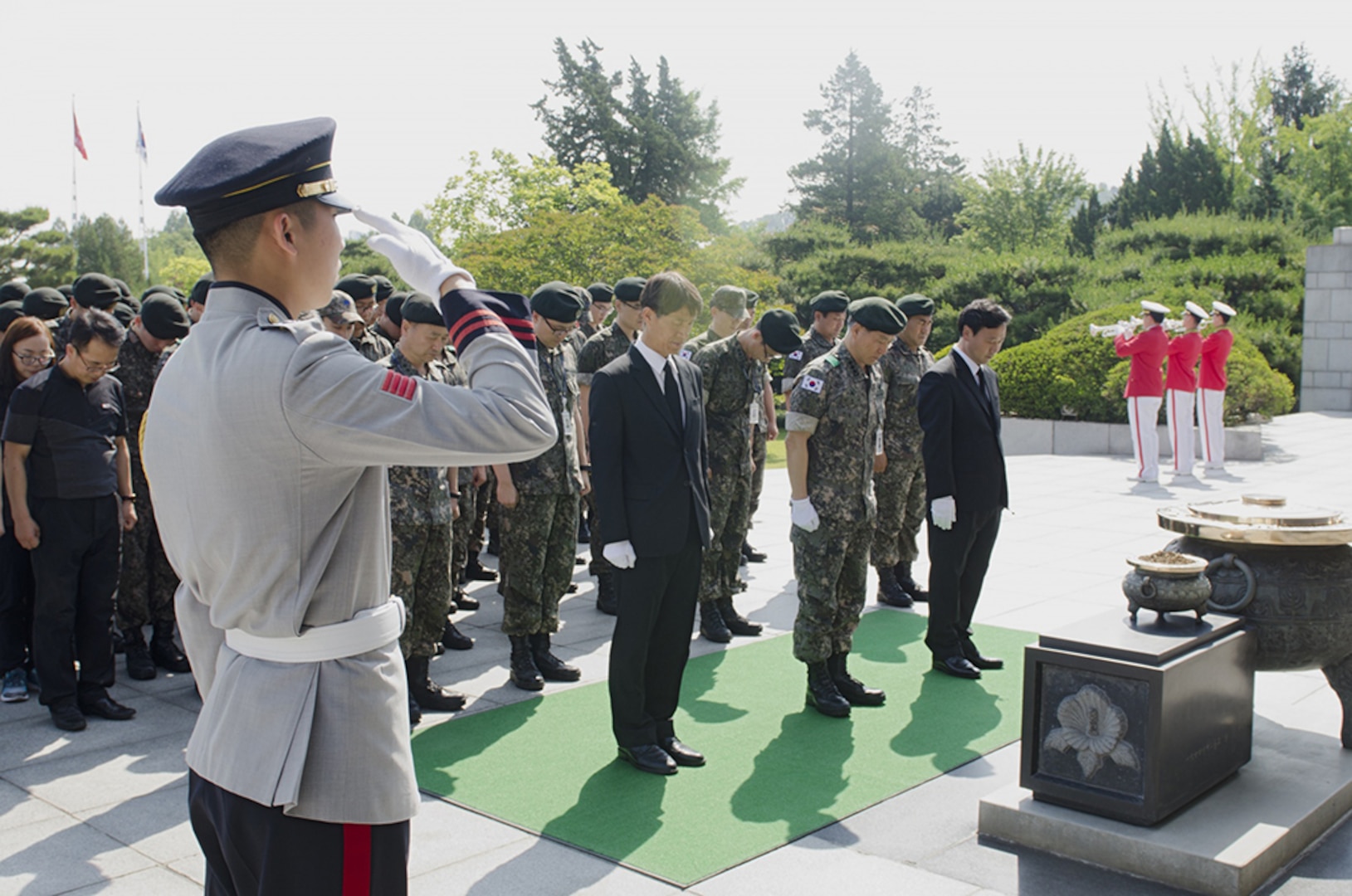 Republic of Korea Soldiers and civilian employees of the Agency for KIA Recovery and Identification, Ministry of National Defense, mourn for the military dead June 3 in front of the memorial tower at the Seoul National Cemetery in Seoul, South Korea. 