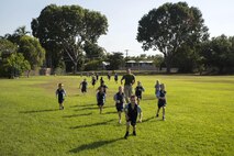 Lance Cpl. Matthew T. Bowden runs with students during physical education at Larrakeyah Primary School, Northern Territory, Australia, on June 2, 2016. Marines with the Forward Coordination Element, Marine Rotational Force – Darwin, volunteered to help with classes at the school. Bowden, from Manville, New Jersey, is a cyber network operator with FCE, MRF-D.