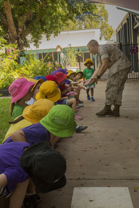 1st Lt. J.C. Wright high-fives preschool students at Larrakeyah Primary School, Northern Territory, Australia, on June 2, 2016. Marines with the Forward Coordination Element, Marine Rotational Force – Darwin, volunteered to help with classes at the school. Wright, from Bogata, Texas, is a communications officer with FCE, MRF-D.