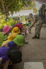 1st Lt. J.C. Wright high-fives preschool students at Larrakeyah Primary School, Northern Territory, Australia, on June 2, 2016. Marines with the Forward Coordination Element, Marine Rotational Force – Darwin, volunteered to help with classes at the school. Wright, from Bogata, Texas, is a communications officer with FCE, MRF-D.