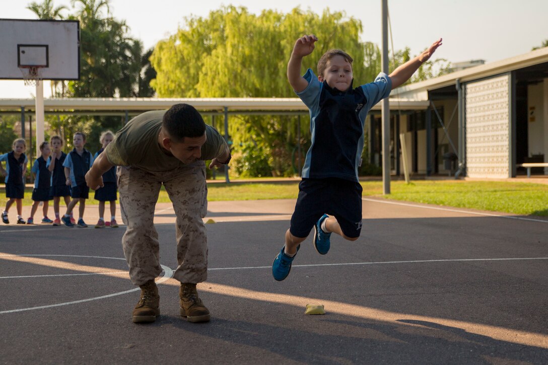 Lance Cpl. Adrian Lozano jumps with students during physical education at Larrakeyah Primary School, Northern Territory, Australia, on June 2, 2016. Marines with the Forward Coordination Element, Marine Rotational Force – Darwin, volunteered to help with classes at the school. Lozano, from Los Angeles, California, is an administration specialist with FCE, MRF-D.