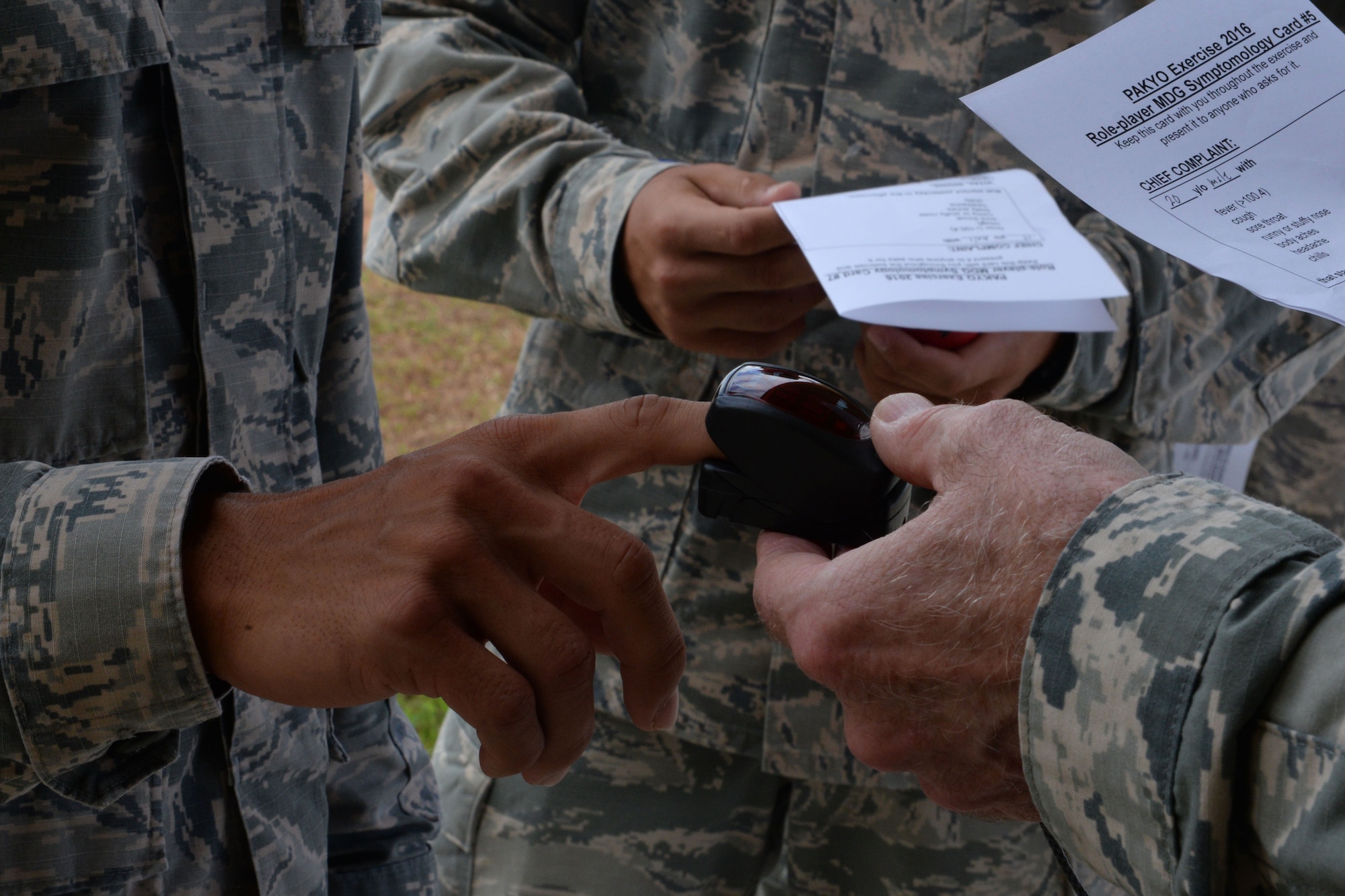 Medical technicians check a patient’s pulse during a typhoon recovery exercise June 6, 2016, at Andersen Air Force Base, Guam. Airmen assigned to the 36th Medical Group regularly practice established response scenarios to maintain readiness during contingencies and public health emergencies. (U.S. Air Force photo by Airman 1st Class Alexa Ann Henderson/Released)