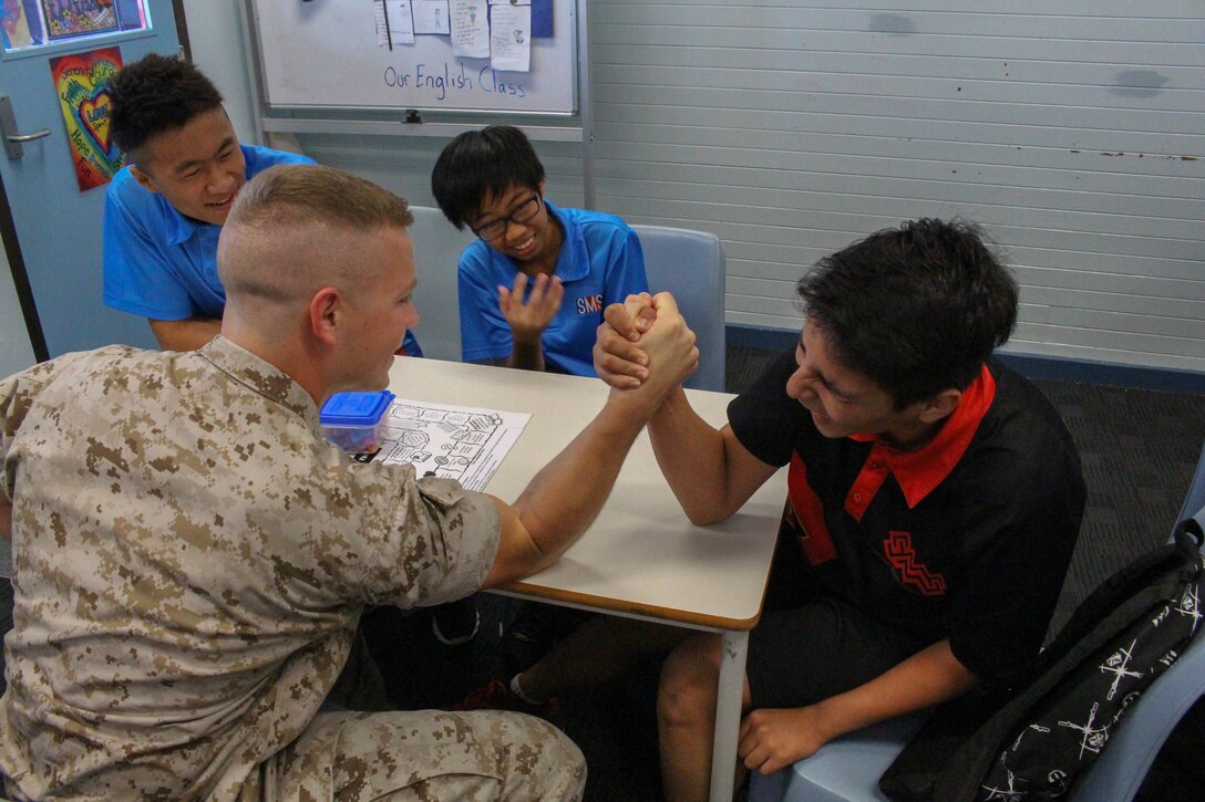 1st Lt. Joseph C. Wright arm wrestles a student at Sanderson Middle School, Northern Territory, Australia, on June 3, 2016. Marines with the Forward Coordination Element, Marine Rotational Force – Darwin, helped with an English oral language class by talking, playing and listening to middle school students. Wright, from Bogata, Texas, is a communications officer with FCE, MRF-D.
