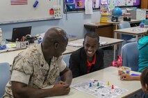 Sgt. Samuel T. Gbatu converses with a student at Sanderson Middle School, Northern Territory, Australia, on June 3, 2016. Marines with the Forward Coordination Element, Marine Rotational Force – Darwin, helped with an English oral language class by talking, playing and listening to middle school students. Gbatu, from Brooklyn Park, Minnesota, is an administrative specialist with FCE, MRF-D.