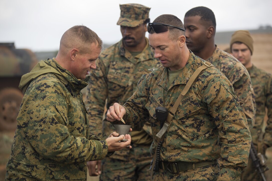 U.S. Navy Lt. Michael S. Kennedy, Marine Rotational Force – Darwin Chaplain, serves communion to Maj. Christopher W. Simpson, Company C Commander, at the Company C bivouac in Cultana Training Area, South Australia, Australia, June 5, 2016. Military chaplains serve all spiritual needs and ensure service members are afforded the opportunity to practice their religion freely. Kennedy is from Huntsville, Alabama. Simpson, from Rochester, New York, is with 1st Battalion, 1st Marine Regiment.