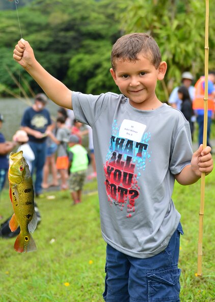Aiden Witmer holds up his trophy winning fish during the annual Friends of Hickam Keiki Fishing Tournament at the Ho`omaluhia Botanical Gardens in Kaneohe, Hawaii, June 2, 2016. More than 150 Airmen and their children from Joint Base Pearl Harbor-Hickam attended the fishing tournament in its 17th year. The Friends of Hickam is a non-profit organization composed of civic and business leaders in the local community who are interested in showing support for the Air Force in Hawaii. (U.S. Air Force photo by Tech. Sgt. Aaron Oelrich/Released) 