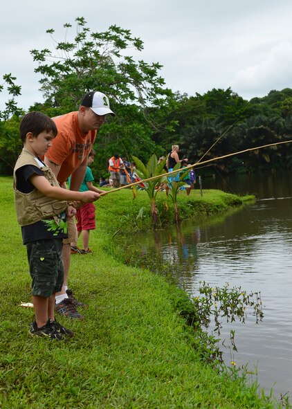 Tech. Sgt. Adam Speights, 15th Aircraft Maintenance Squadron, gives fishing tips to his son during the annual Friends of Hickam Keiki Fishing Tournament at the Ho`omaluhia Botanical Gardens in Kaneohe, Hawaii, June 2, 2016. More than 150 Airmen and their children from Joint Base Pearl Harbor-Hickam attended the fishing tournament in its 17th year. The Friends of Hickam is a non-profit organization composed of civic and business leaders in the local community who are interested in showing support for the Air Force in Hawaii. (U.S. Air Force photo by Tech. Sgt. Aaron Oelrich/Released) 