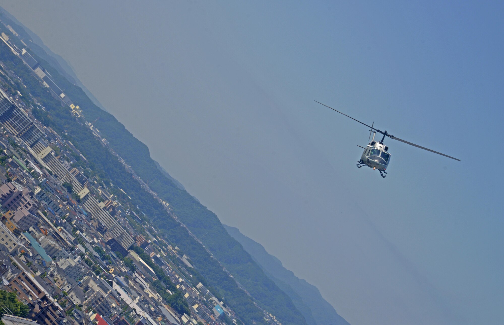 A UH-1N Iroquois with the 459th Airlift Squadron flies over Japan, June 3, 2016. The formation flight provided the aircrew with an opportunity to practice flight procedures and prepare for real-world missions. (U.S. Air Force photo by Senior Airman David Owsianka/Released)