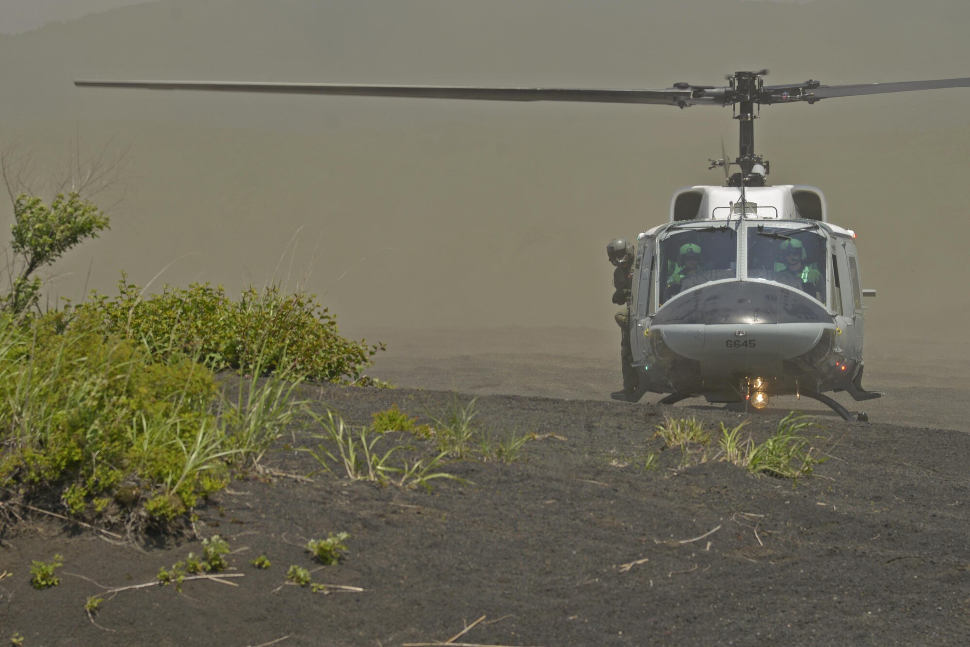 Pilots of a UH-1N Iroquois with the 459th Airlift Squadron land at a drop zone near Mt. Fuji, Japan, June 3, 2016. The formation flight allowed the aircraft to fly together while gaining proficiency in different landing environments such as an airfield, grass field and a mountain landing zone. (U.S. Air Force photo by Senior Airman David Owsianka/Released)