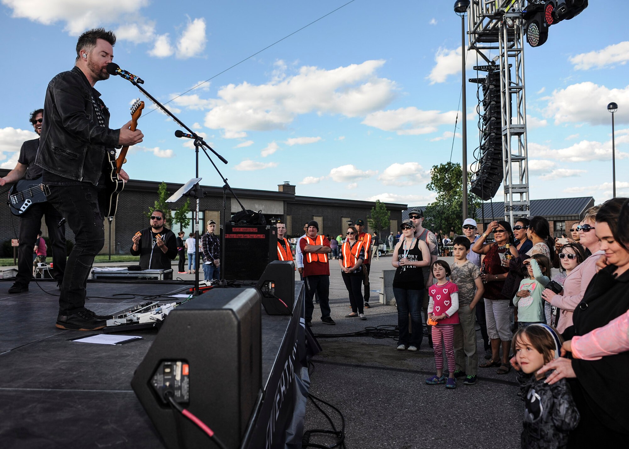 David Cook, left, winner of season seven of “American Idol,” performs a free concert for Airmen and their families outside the Dakota’s Club at Ellsworth Air Force Base, S.D., June 3, 2016. Prior to winning “American Idol,” Cook was working as a bartender and fronting his own band. (U.S. Air Force photo by Airman 1st Class Denise M. Nevins/Released)
