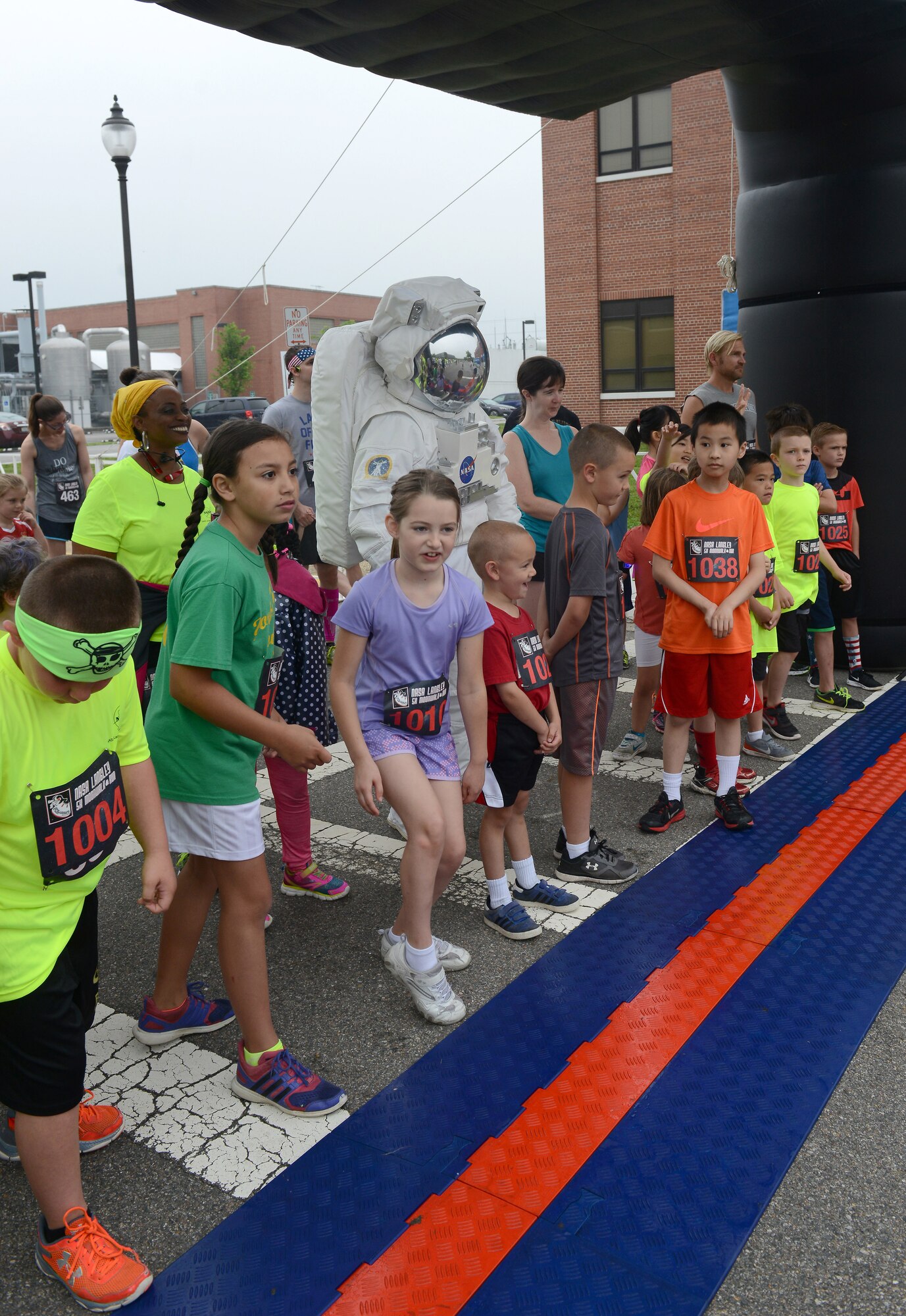 Children from the Hampton Roads community line up with an astronaut in preparation for the NASA Langley Research Center Moonwalk and Run 5K at NASA LaRC, Va., June 4, 2016. LaRC Kids ran a one-mile course before cheering on family members who participated in the 5K. (U.S. Air Force photo by Staff Sgt. Teresa J. Cleveland)