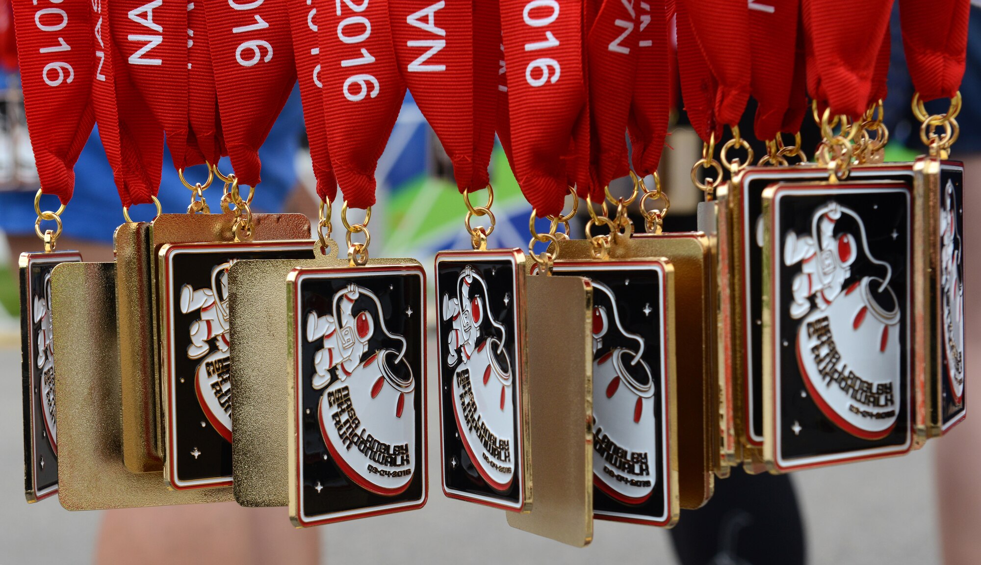 Medals were awarded to participants of the 3rd annual NASA Langley Research Center Moonwalk and Run 5K at NASA LaRC, Va., June 4, 2016. Following the run, the event included snacks, music, games and activities for children. (U.S. Air Force photo by Staff Sgt. Teresa J. Cleveland)