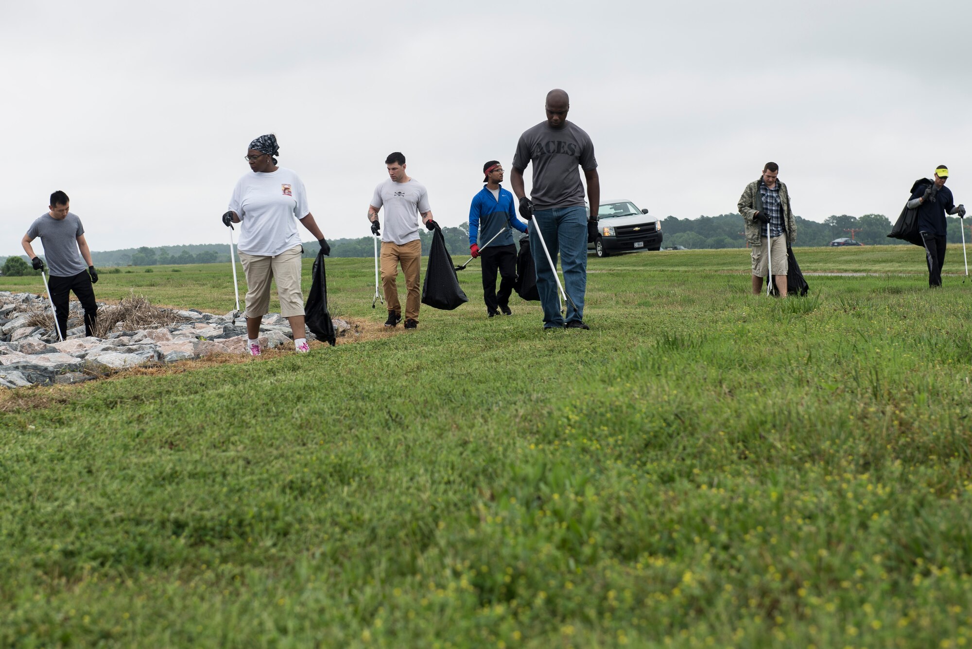 A group of volunteers walk along the shoreline gathering trash during the 28th annual Clean the Bay Day at Langley Air Force Base, Va., June 4, 2016. Many volunteers have returned several years in a row to clean the installation and keep the Chesapeake Bay free of trash. (U.S. Air Force photo by Airman 1st Class Derek Seifert)