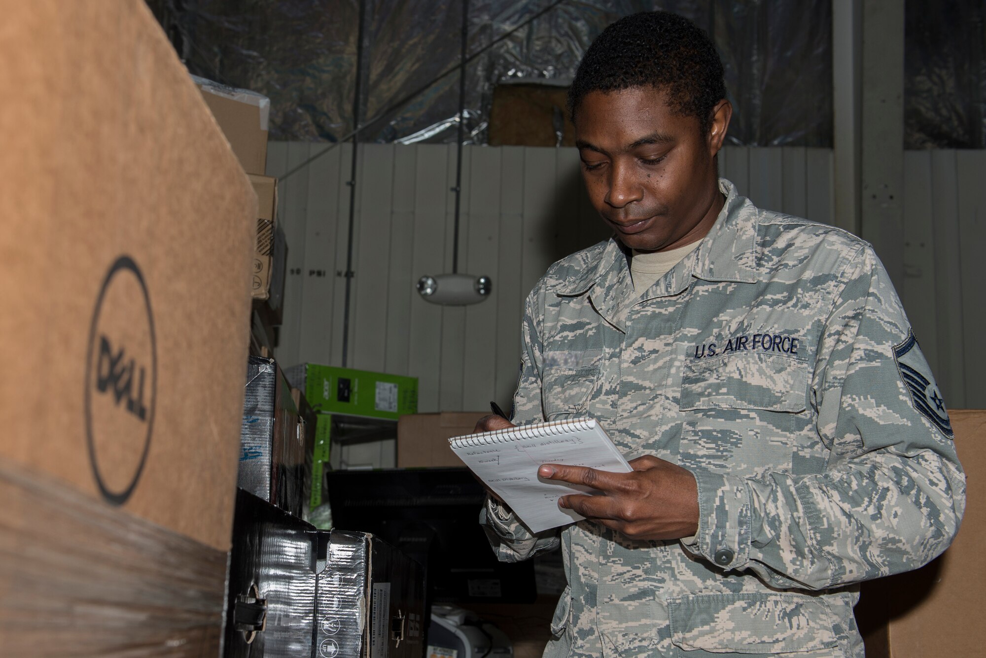 U.S. Air Force Master Sgt. George, asset manager for the 363rd Intelligence Support Squadron, 363rd Intelligence, Surveillance and Reconnaissance Group, 363rd ISR Wing, inspects serial numbers for inventory at Langley Air Force Base, Va., May 24, 2016. George is in charge of a $3 million asset management program for the 363rd ISRW. (U.S. Air Force photo by Airman 1st Class Derek Seifert)
