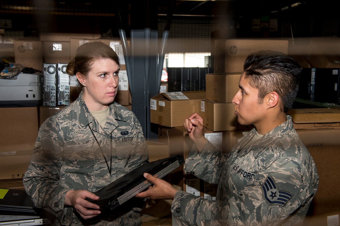U.S. Air Force Staff Sgt. Magda, cyber systems noncommissioned officer-in-charge for the 363d Intelligence Support Squadron, provides inventory training to Airman 1st Class Jenny, cyber system operator for the 363d ISS, at Langley Air Force Base, Va., May 24, 2016. Cyber system operators design, install and support cyber systems to ensure they operate properly and remain secure from outside intrusion. (U.S. Air Force photo by Airman 1st Class Derek Seifert)
