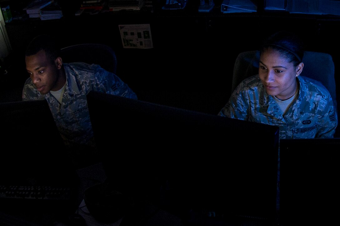 U.S. Air Force Senior Airmen Jeremy and Tiffany, analysts from the 36th Intelligence Squadron, 363rd Intelligence, Surveillance and Reconnaissance Group, 363rd ISR Wing, analyze imagery at Langley Air Force Base, Va., May 24, 2016. These Airmen are performing duties known as “weaponeering,” the process of determining the quantity of a specific type of weapon required to achieve a specific level of damage to a given target. (U.S. Air Force photo by Airman 1st Class Derek Seifert) 
