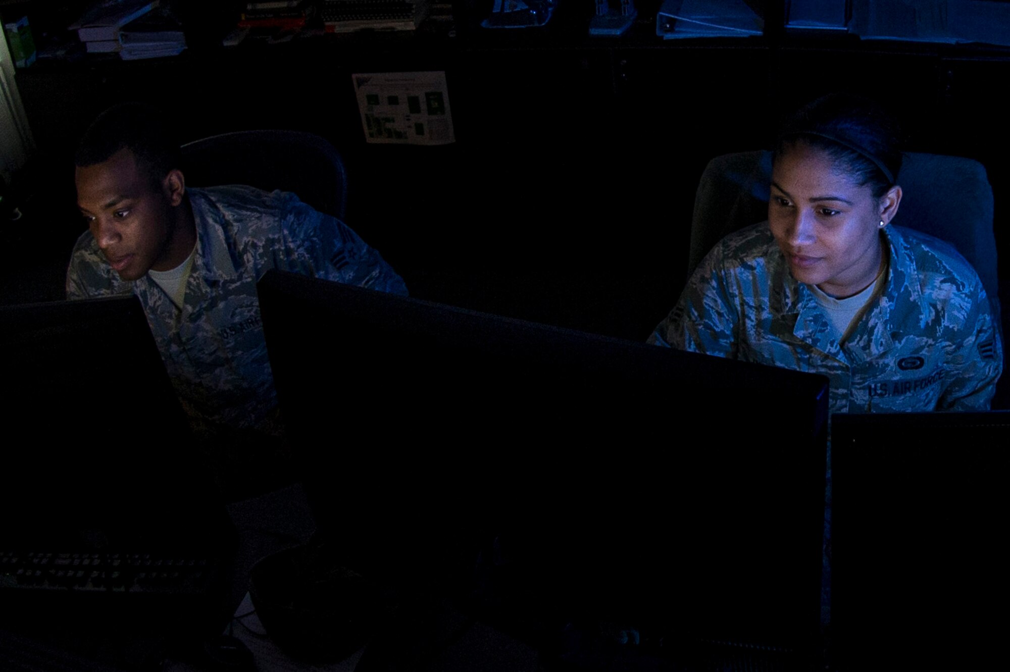 U.S. Air Force Senior Airmen Jeremy and Tiffany, analysts from the 36th Intelligence Squadron, 363rd Intelligence, Surveillance and Reconnaissance Group, 363rd ISR Wing, analyze imagery at Langley Air Force Base, Va., May 24, 2016. These Airmen are performing duties known as “weaponeering,” the process of determining the quantity of a specific type of weapon required to achieve a specific level of damage to a given target. (U.S. Air Force photo by Airman 1st Class Derek Seifert) 