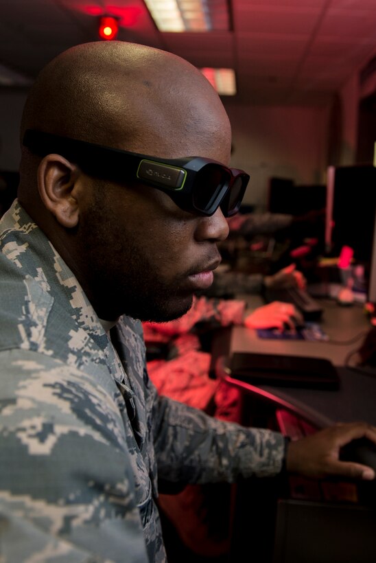 U.S. Air Force Airman Lauren and Staff Sgt. Michael, target system analysts for the 15th Intelligence Squadron, discuss career development courses and operational targeting training at Langley Air Force Base, Va., May 24, 2016. The 15th IS is part of the 365th Intelligence, Surveillance and Reconnaissance Group, 363rd ISR Wing, which serves as content-dominant analysis, precision targeting production, and special operations ISR for the tactical warfighter, enabling combat power in air, space, and cyberspace. (U.S. Air Force photo by Airman 1st Class Derek Seifert)